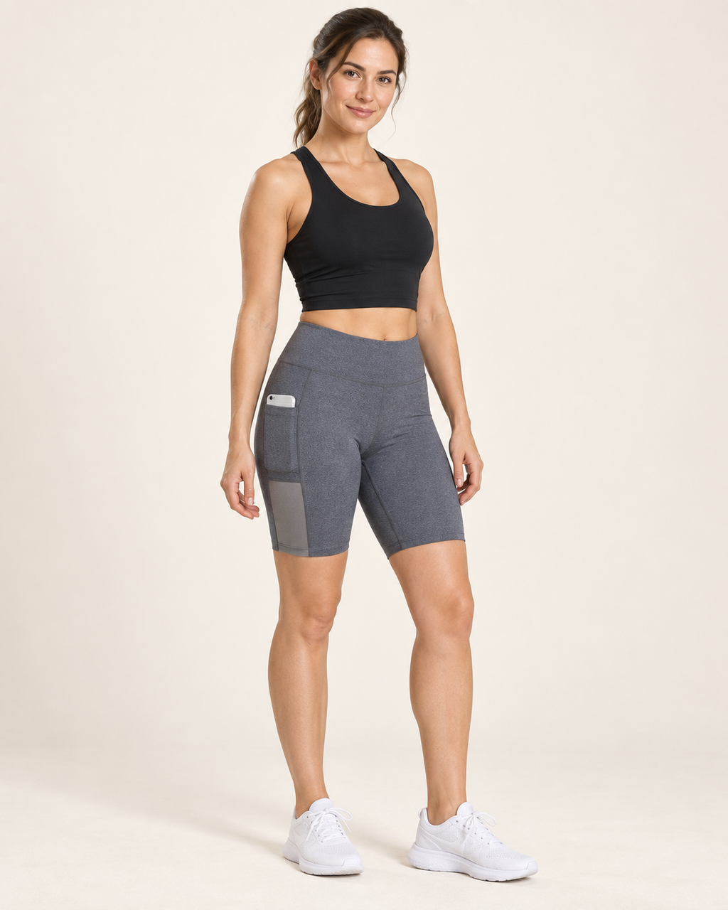 AI-generated studio visualization of a woman wearing gray stretch yoga shorts with a side phone pocket.