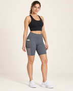 AI-generated studio visualization of a woman wearing gray stretch yoga shorts with a side phone pocket.